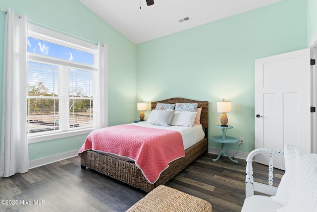 bedroom featuring ceiling fan, dark hardwood / wood-style flooring, and vaulted ceiling