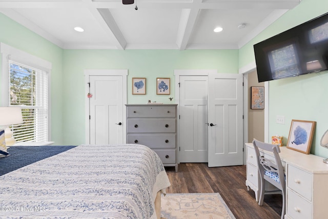 bedroom featuring beam ceiling and dark hardwood / wood-style flooring