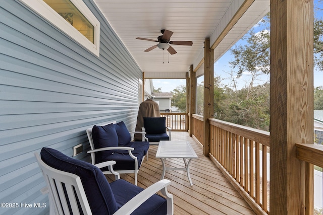 wooden deck featuring ceiling fan