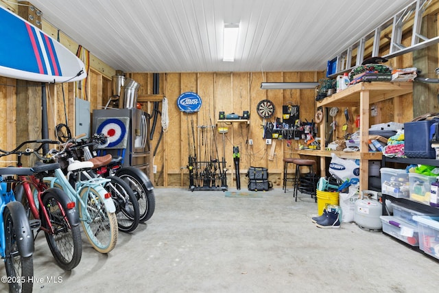 garage with a workshop area and electric panel