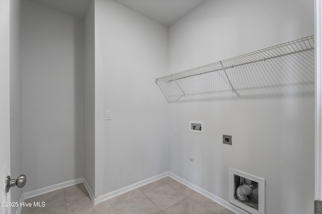 laundry area featuring gas dryer hookup, hookup for an electric dryer, hookup for a washing machine, and light tile patterned floors