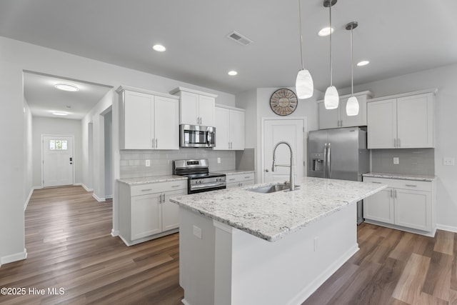 kitchen featuring white cabinetry, appliances with stainless steel finishes, sink, and a center island with sink