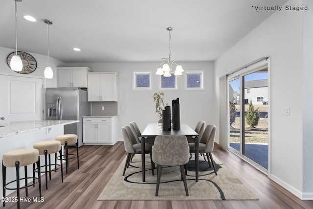 dining area featuring an inviting chandelier and wood-type flooring