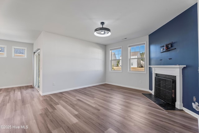 unfurnished living room with wood-type flooring