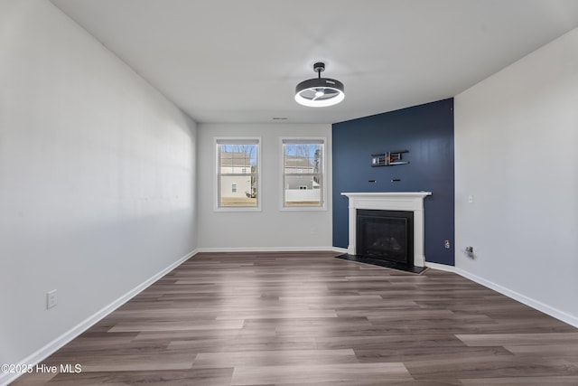 unfurnished living room featuring dark hardwood / wood-style floors