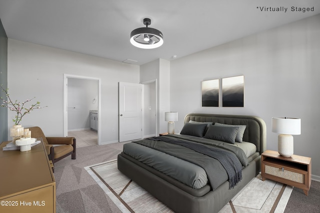 carpeted bedroom featuring ensuite bathroom