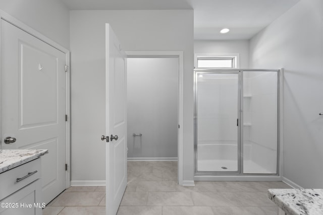 bathroom with tile patterned floors, vanity, and an enclosed shower