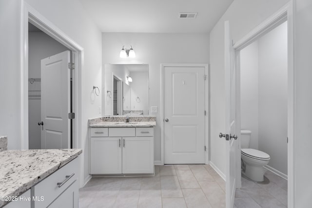 bathroom with tile patterned floors, vanity, and toilet