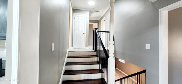 staircase with hardwood / wood-style flooring and ornamental molding