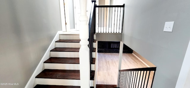 stairway featuring hardwood / wood-style flooring