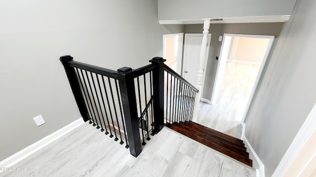 staircase with wood-type flooring