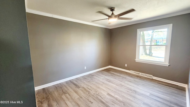 unfurnished room featuring crown molding, ceiling fan, light hardwood / wood-style floors, and a textured ceiling