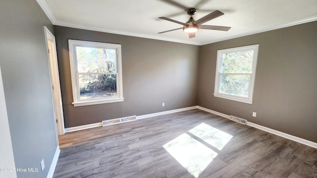 empty room featuring ornamental molding, light hardwood / wood-style floors, and ceiling fan