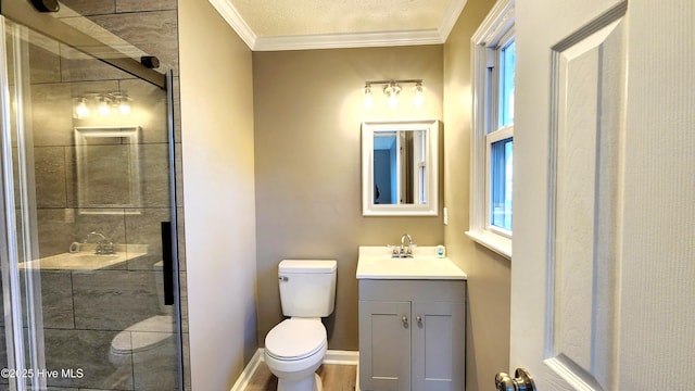 bathroom featuring vanity, crown molding, toilet, and walk in shower