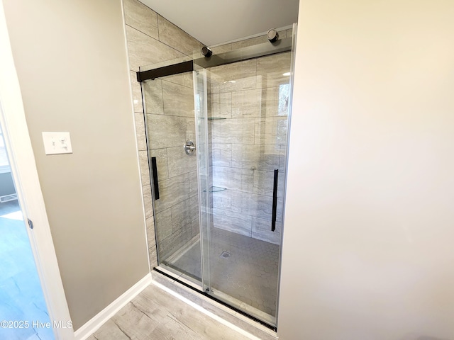 bathroom featuring hardwood / wood-style flooring and an enclosed shower