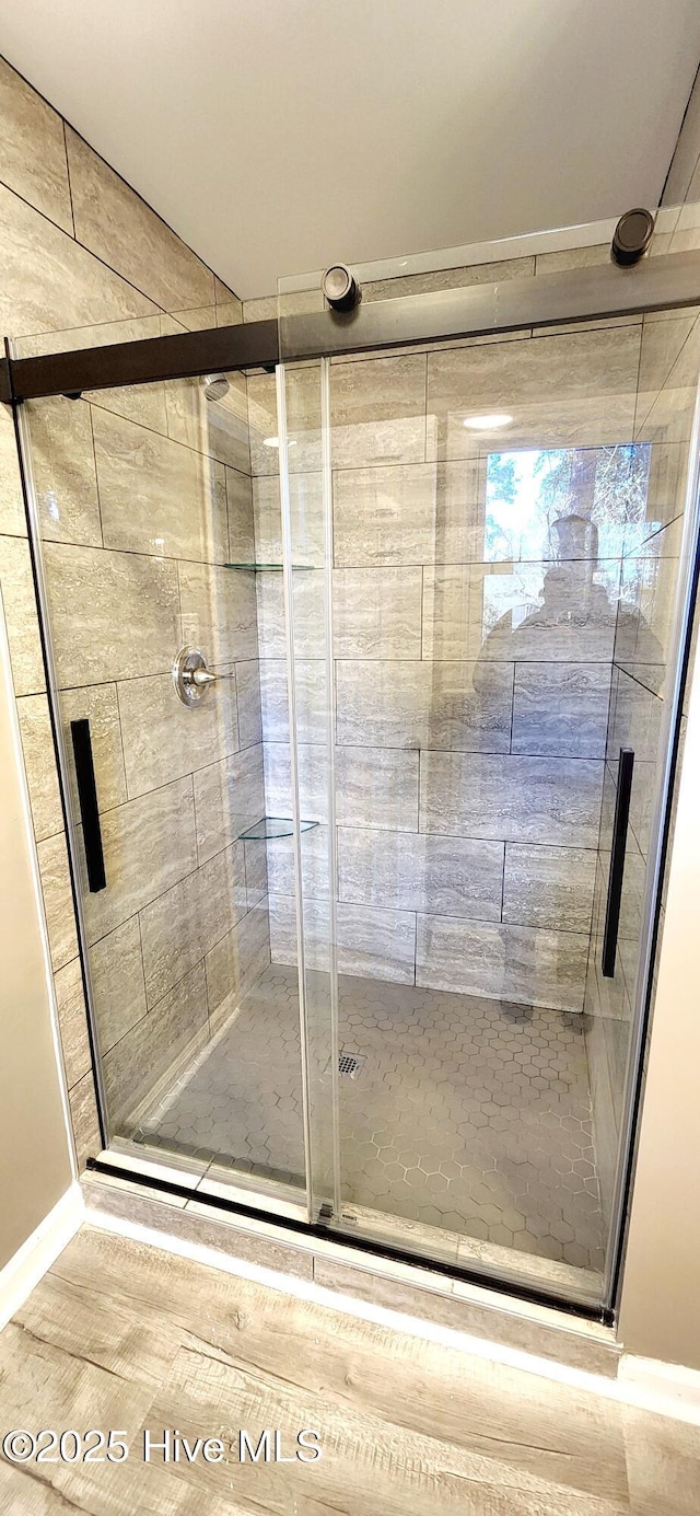 bathroom featuring a shower with shower door