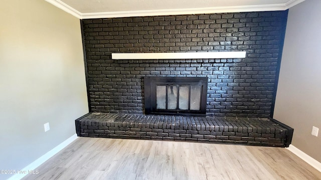 interior details with crown molding, a brick fireplace, and hardwood / wood-style flooring