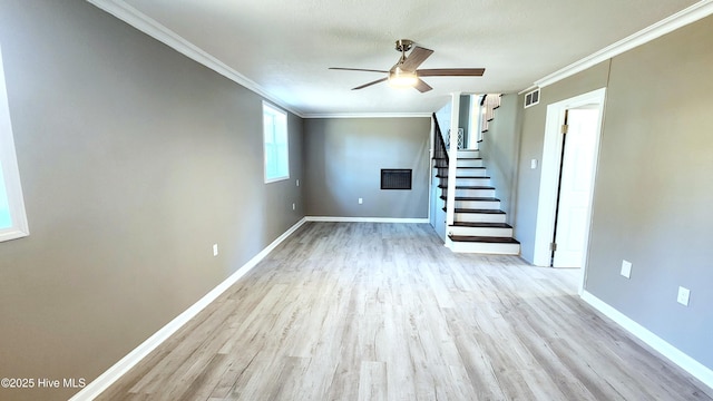 basement with ornamental molding, ceiling fan, and light wood-type flooring