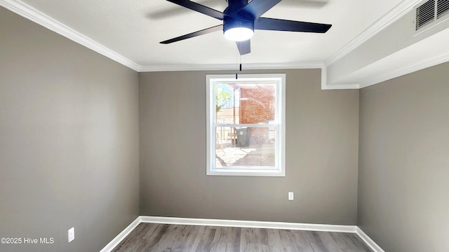 empty room with crown molding, ceiling fan, and light wood-type flooring