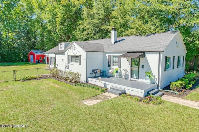 view of front of house with a wooden deck and a front yard