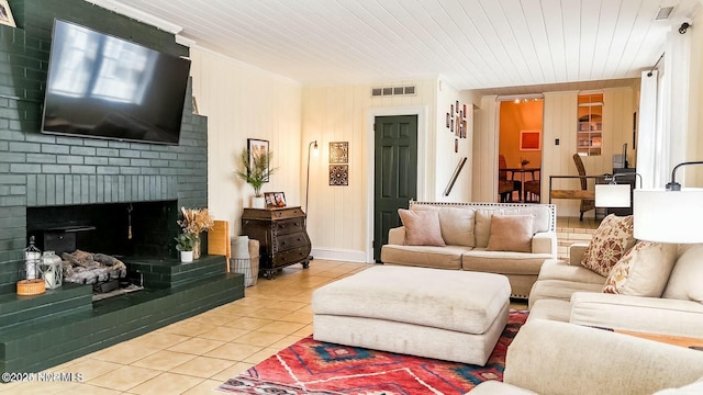 tiled living room featuring a brick fireplace and wooden ceiling