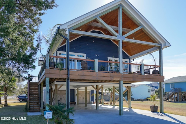 back of house featuring a carport, a wooden deck, and central air condition unit