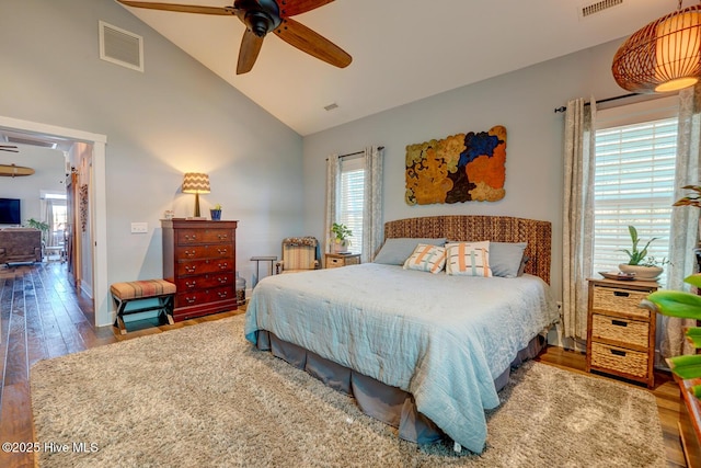 bedroom featuring ceiling fan, wood-type flooring, and high vaulted ceiling