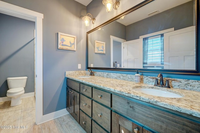 bathroom with vanity and toilet