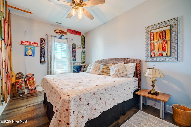 bedroom with dark hardwood / wood-style floors and ceiling fan