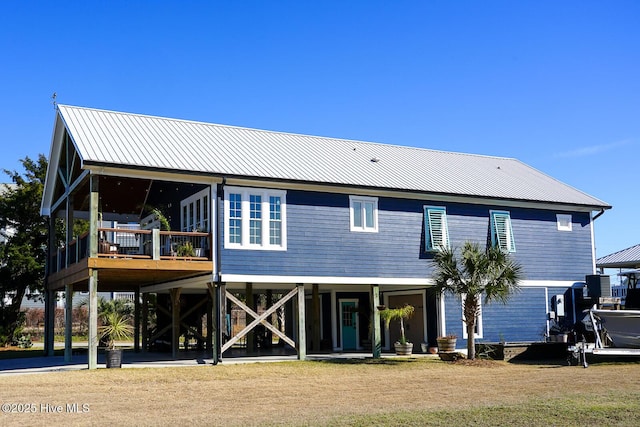 rear view of property featuring a yard