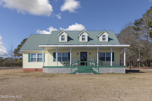 view of front of home with crawl space, metal roof, a porch, and a front yard