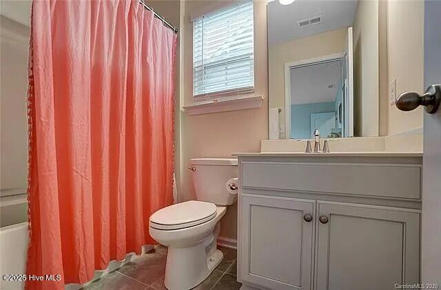 bathroom featuring toilet, baseboards, and wood finished floors