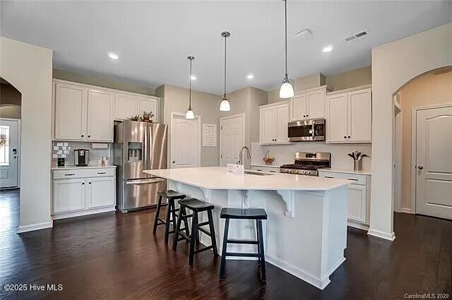 details with a glass covered fireplace, baseboards, and wood finished floors