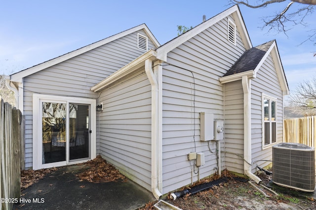 rear view of property featuring central AC unit