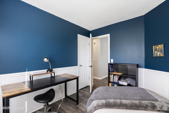 bedroom with wood-type flooring and a textured ceiling