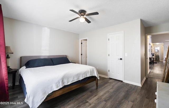 bedroom with dark hardwood / wood-style flooring, ceiling fan, and a textured ceiling