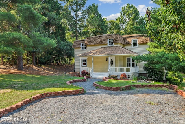 view of front facade with covered porch and a front yard