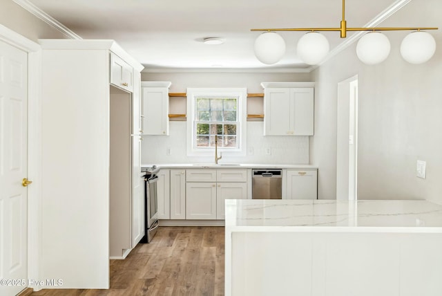 kitchen with sink, white cabinets, light stone counters, stainless steel appliances, and crown molding