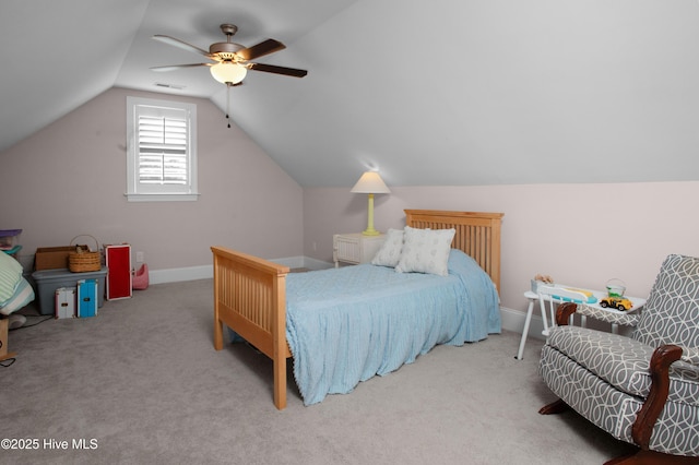 carpeted bedroom with visible vents, baseboards, ceiling fan, and vaulted ceiling