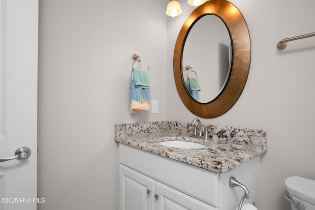 bathroom featuring toilet and vanity