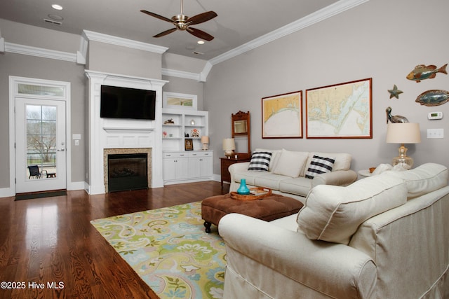 living area featuring a fireplace, wood finished floors, a ceiling fan, and ornamental molding