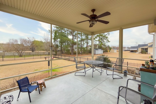 sunroom featuring a ceiling fan