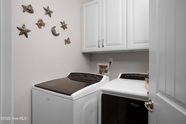 laundry room with cabinet space and separate washer and dryer