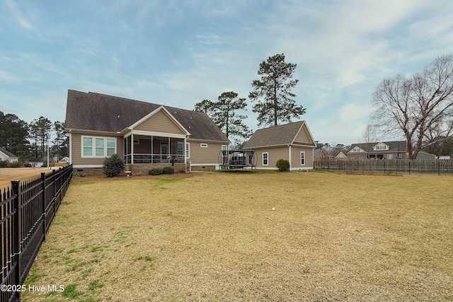 back of property with crawl space, a yard, a fenced backyard, and a sunroom