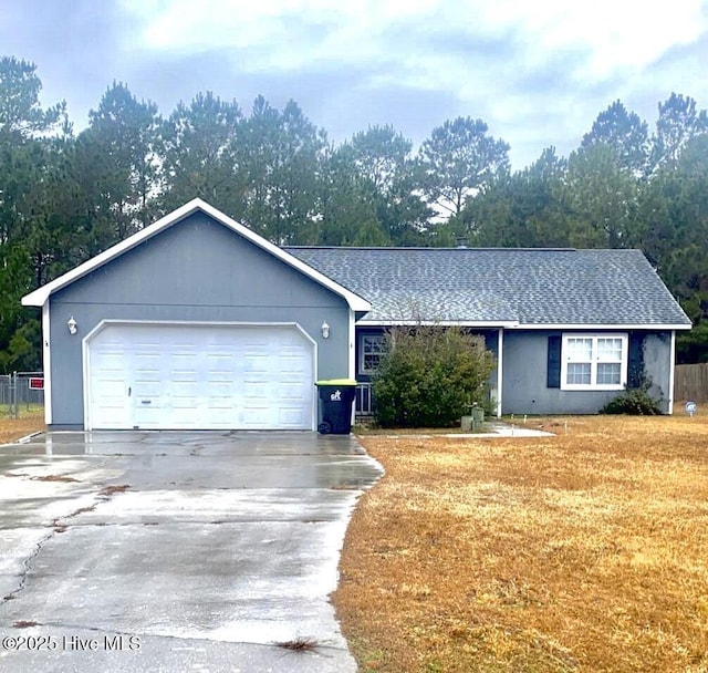 ranch-style house with a garage and a front lawn