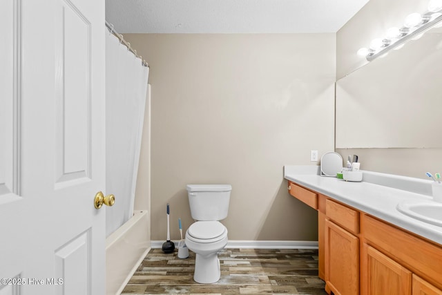 full bathroom with hardwood / wood-style flooring, vanity, toilet, and shower / tub combo