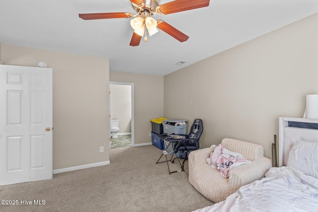 carpeted bedroom with ceiling fan and ensuite bathroom