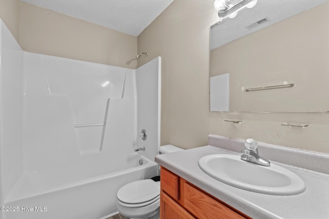 full bathroom featuring vanity, toilet, bathing tub / shower combination, and a textured ceiling