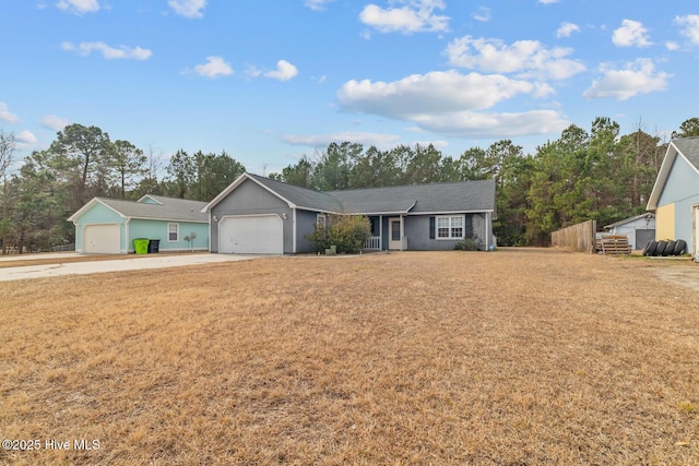 ranch-style house featuring a garage and a front yard