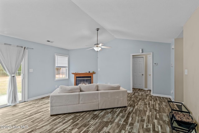 living room featuring lofted ceiling, hardwood / wood-style flooring, and ceiling fan